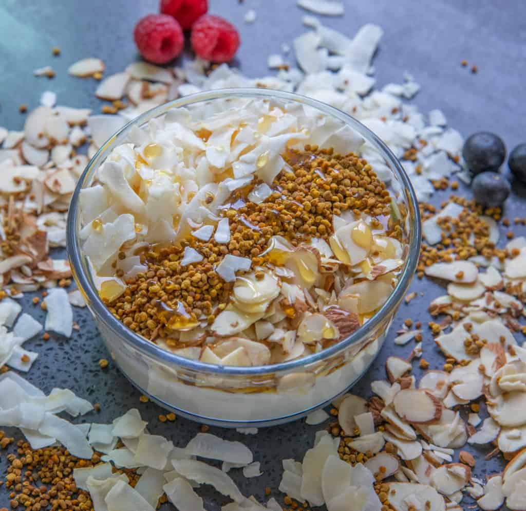 A bowl of yogurt with nuts, honey and HummingBee