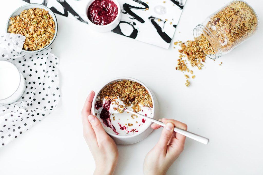 Jar and bowl of granola, yogurt and bee pollen, HummingBee 